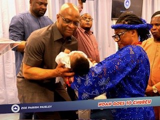 Pastor Edmund dedicating a baby